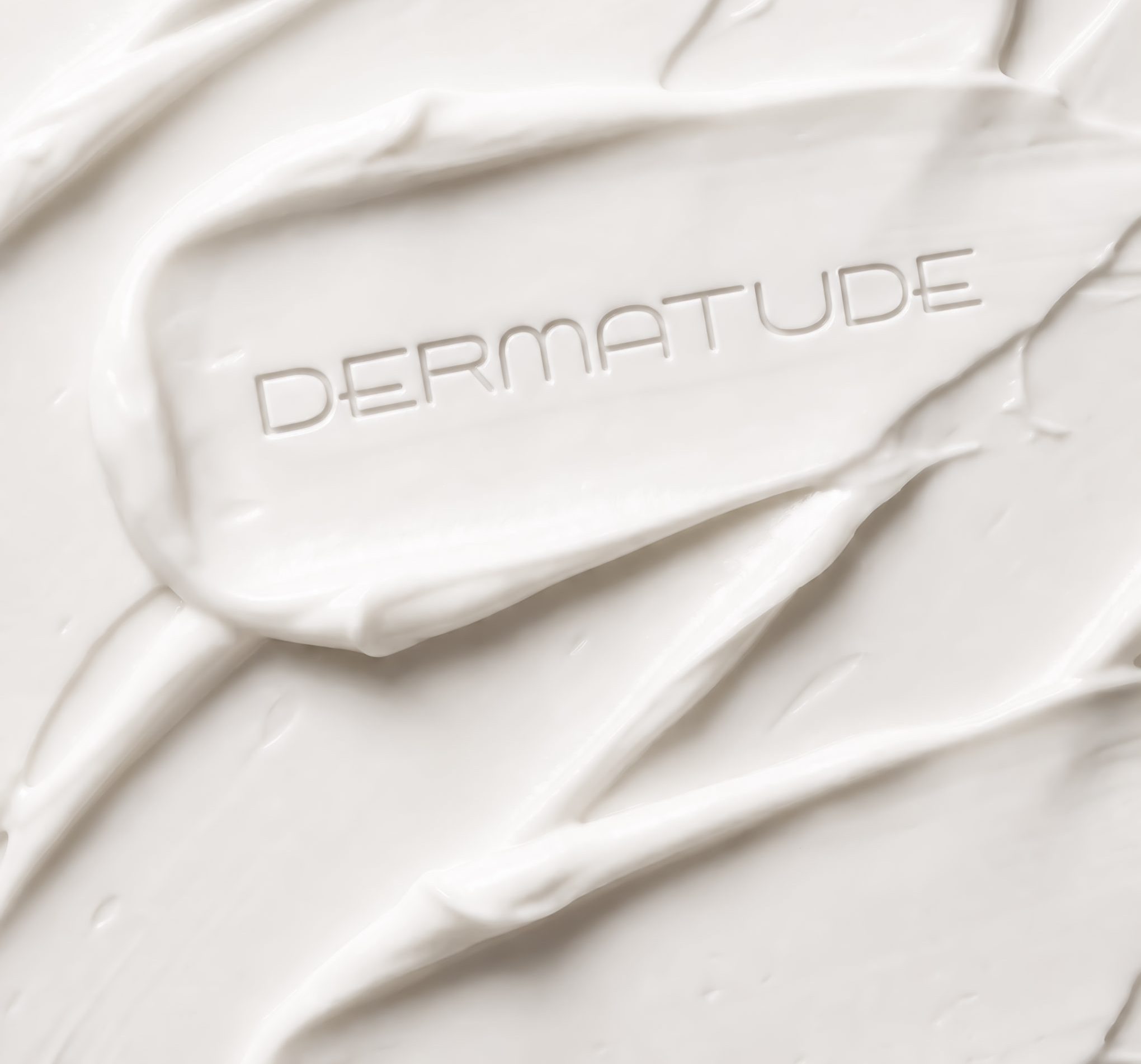 Dermatude skincare cream with dermatude logo written